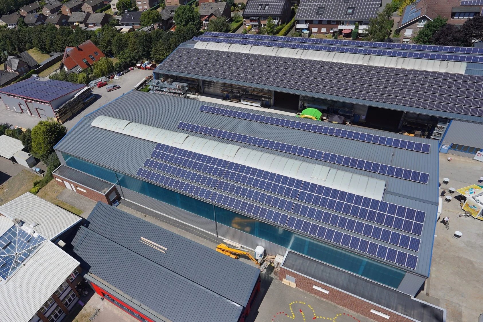 Dach eines Industriegebäudes mit Solarpanels Das Bild zeigt eine große Dachfläche eines Industriegebäudes, das mit Solarpanels bedeckt ist.