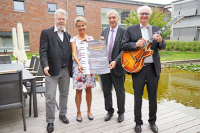 C. Bleiming, A. Evers, T. Borgert, A. Grund mit Plakat Boogie und Blues Festival 2018 